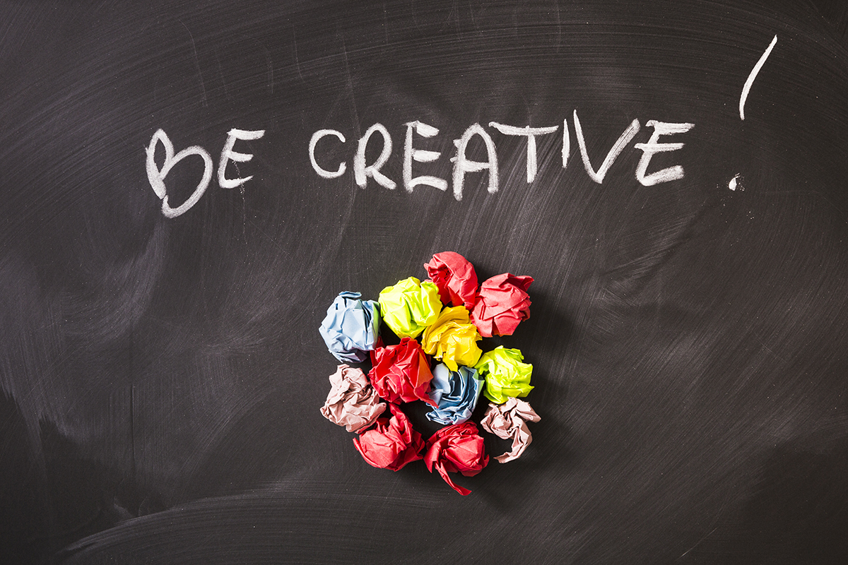 written creative text colorful crumpled paper balls chalkboard